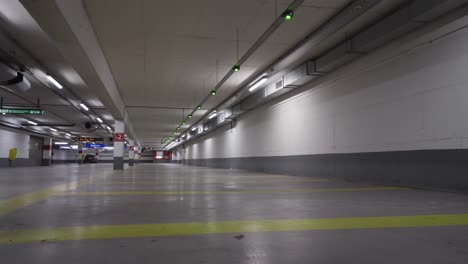 Smart-parking-zone-with-green-blinking-lights-indicating-free-available-parking-space-for-vehicles