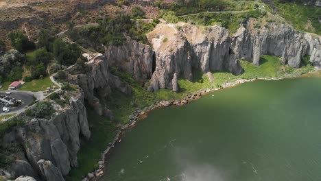 Aerial-upward-tilt-of-the-cliffs-along-the-Snake-River-and-mist-from-Shoshone-Falls-in-the-foreground-near-Twin-Falls,-Idaho