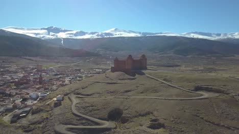 Drone-shot-of-the-renaissance-fortress-of-La-Calahorra-in-Granada,-Spain