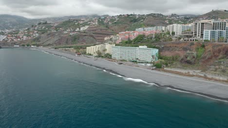 Popular-beach-Praia-Formosa-with-no-people,-waterfront-apartment-buildings