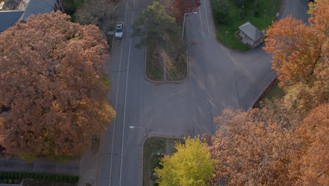 Overhead-view-of-pretty-boulevard-in-Autumn-at-peak-color-with-pull-down-the-street