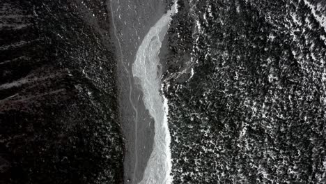 Receding-melting-glacial-landscape,-aerial-top-down-view-of-frozen-river-valley