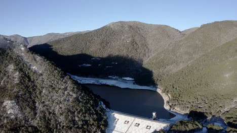 Jade-Dragon-Snow-Mountain-frozen-lake-and-large-hydroelectric-dam,-aerial-view