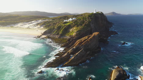Aerial-shot-of-lighthouse-at-sunset-on-rocky-Australia-east-coast