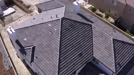 Detached-new-house.-Aerial-orbit-descending,-rooftop-structure