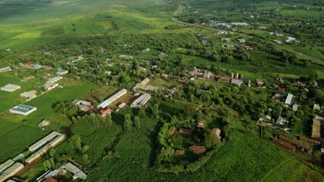 Aerial-view-overlooking-a-small-town,-in-Kenya,-Africa---descending,-drone-shot