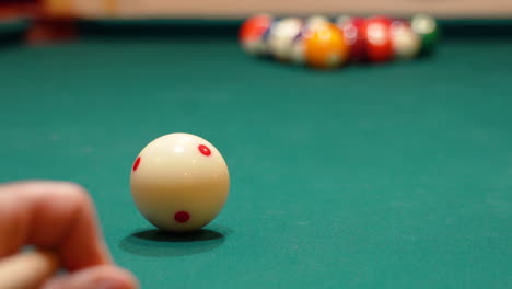 Low-Angle-Closeup-of-Cue-Ball-as-Person-Breaks-Rack-of-8-Ball-Powerfully-on-Pool-Table-with-Green-Felt-and-Cue-Stick-Bending-as-Both-Solid-and-Stripe-Balls-Scatter,-Close-Bridge-Hand,-No-Faces-in-Bar