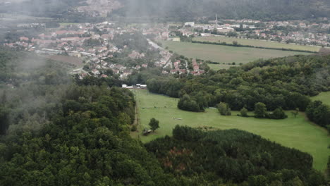 Aerial-Shot-Of-Forest-Mountain-Above-A-Small-Rural-City-In-Czech-Republic
