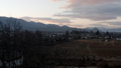 Rural-Chinese-village-in-mountainous-region,-morning-sunrise-aerial-view