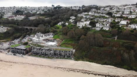 Aerial-backwards-shot-of-Carbis-Bay-and-hotel-in-Cornwall-England-UK