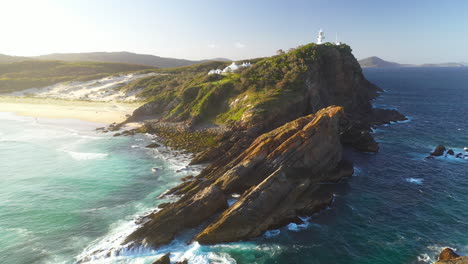 Sugarloaf-Point-Lighthouse-over-Seal-Rocks,-NSW-Australia-coast,-sunset-aerial