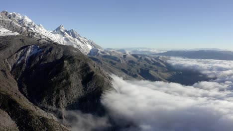Increíble-Vista-Aérea-De-La-Montaña-Del-Dragón-De-Jade-Chino-Que-Se-Eleva-Por-Encima-De-Las-Nubes,-Yunnan