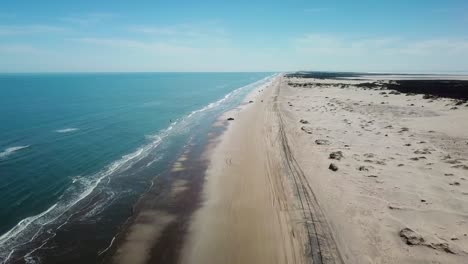 Aerial-drone-view-of-beach-at-low-tide-on-a-gulf-coast-barrier-island-on-a-sunny-afternoon-at-low-tide---South-Padre-Island,-Texas
