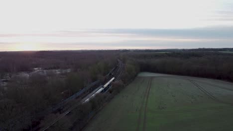 Drone-footage-of-a-morning-train-arriving-at-a-village-train-station-in-England