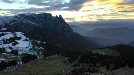 Aerial-shot-of-mountains-in-the-Dolomites-at-sunset-seen-from-alpine-meadow-Seiser-Alm---Alpe-di-Siusi-plateau-in-South-Tyrol,-Italy
