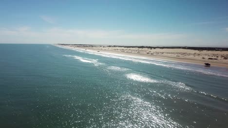Aerial-drone-view-with-increasing-elevation-of-beach-and-sand-dunes-at-low-tide-on-a-gulf-coast-barrier-island-on-a-sunny-afternoon---South-Padre-Island,-Texas