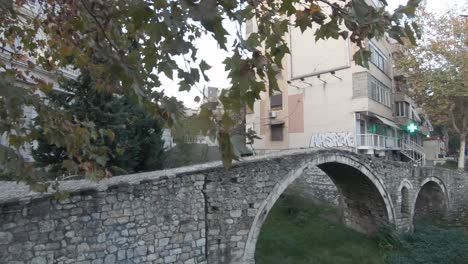 View-of-old-pedestrian-Tanners'-Bridge-in-Tirana,-Albania---Push-in-wide-shot
