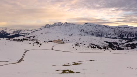 Panoramic-aerial-shot-of-snowy-winter-landscape-at-Dolomite-mountain-range-seen-from-Seiser-Alm---Alpe-di-Siusi-plateau-in-South-Tyrol,-Italy