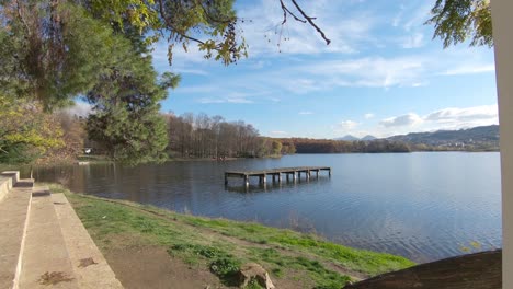 View-from-Grand-Park-stone-gazebo-to-wooden-pier-on-artificial-lake-in-Tirana,-Albania