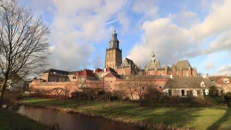 Winter-landscape-timelapse-with-shadows-moving-and-clouds-passing-by-over-picturesque-historic-city-Zutphen-in-The-Netherlands-with-the-church-and-tower-of-the-Walburgiskerk-rising-above