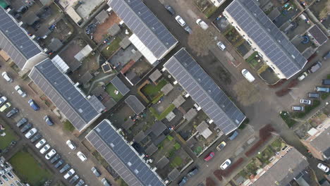 Top-down-aerial-across-residential-neighbourhood-with-solar-panels-on-rooftop