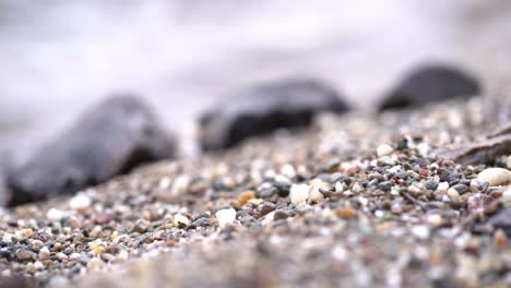 Extremely-slow-motion-pull-focus-between-from-a-rocky-beach-to-rocks-on-the-beach