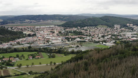 Aerial-Shot-Of-A-Small-City-In-Czech-Republic-Surrounded-By-Forest-And-Beautiful-Mountains