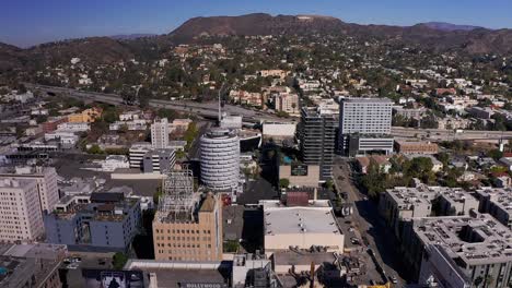 Aerial-tilting-up-shot-of-downtown-Hollywood-with-the-Hollywood-Sign-in-the-background