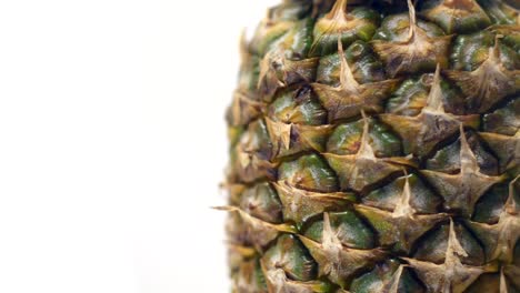 Close-up-of-a-pineapple-rotating-on-a-white-background