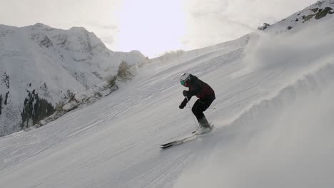 Professional-male-skier-skiing-fast-ski-turns-on-perfect-ski-slope-in-tyrol