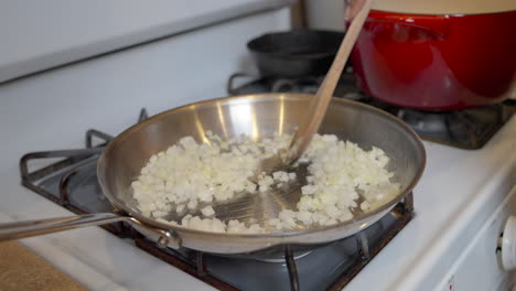 Stirring-sautéed-onions-sizzling-on-the-stove-for-a-homemade-recipe