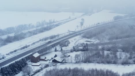 Falling-snow-on-a40-highway,-ruhrschnellweg,-near-Bochum,-aerial-tracking-shot