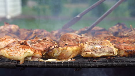 Chicken-grilling-over-a-wood-fire-in-the-outdoor-fire-pit