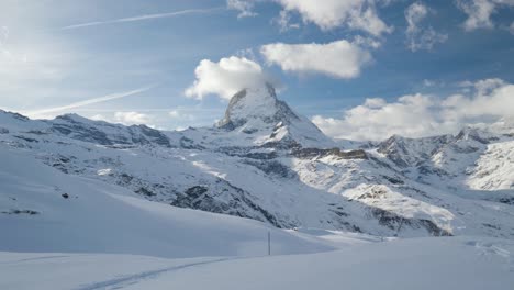 slow-panning-shot-of-snow-covered-mountain-landscape-with-Matterhorn,-swiss-alps-famous-zermatt-glacier-ski-resort