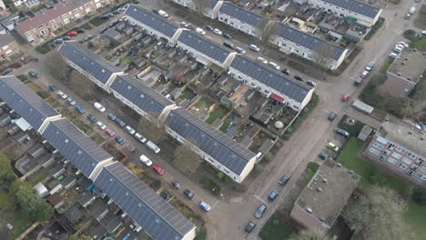 Flying-across-residential-neighbourhood-with-solar-panels-on-rooftop