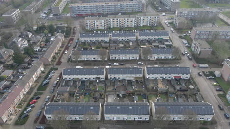 Flying-over-residential-neighbourhood-with-solar-panels-on-rooftop