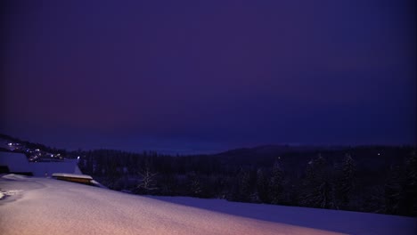 Time-lapse-of-sunset-in-snowy-hill-above-European-town,-Poland,-wide-shot