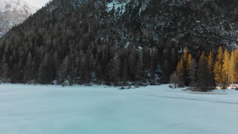 Slow-upward-aerial-tilt-over-a-frozen-Lake-Braies-in-the-Italian-Dolomites