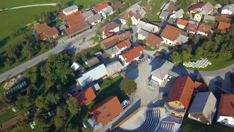Aerial-view-of-residential-houses-with-red-roofs-and-streets-with-parked-cars-in-the-rural-town-area