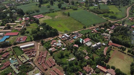 Aerial-View-Of-Countryside-Landscape-With-Fields-And-Old-Structures-In-The-Rural-Town-Of-Loitokitok,-Kenya---aerial-drone-shot