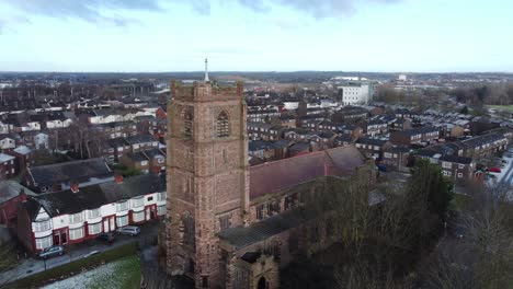 Aerial-view-industrial-small-town-frosty-church-rooftops-neighbourhood-North-West-England