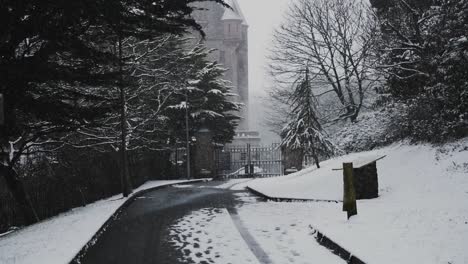 Light-snowfall-outside-gates-of-Belfast-Castle,-slow-motion