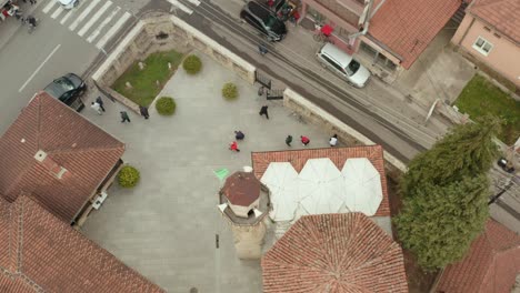 Aerial-view-over-European-Mosque-city-building-and-tower,-people-outside