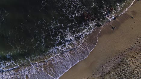 Aerial-birdseye-view-of-ocean-waves-at-the-beach
