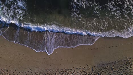 Aerial-view-of-beach-waves,-slowly-moving-to-the-right