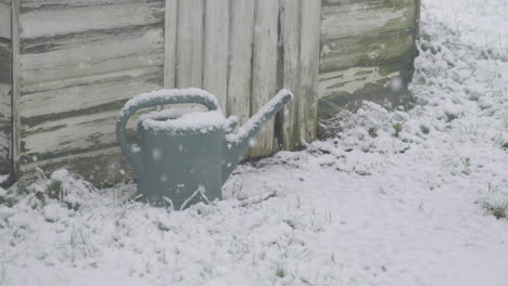 realtime-shot-of-heavy-snow-fall-in-an-english-garden-with-a-shed-and-a-watering-can-todmorden-realtime-footage
