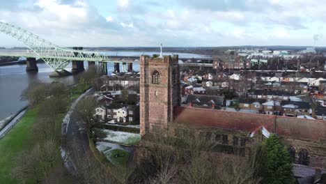Aerial-view-industrial-small-town-Jubilee-bridge-frosty-church-rooftops-neighbourhood-North-West-England-orbit-left