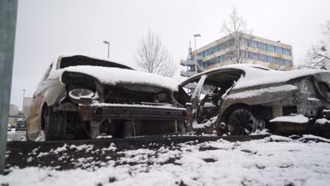 Vandalised-cars-on-city-streets,-snowy-city-crime-scene-arson-attack