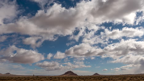 Cumulus-clouds-create-abstract-shapes-above-the-volcanic-cones-in-the-Mojave-Desert---static-time-lapse