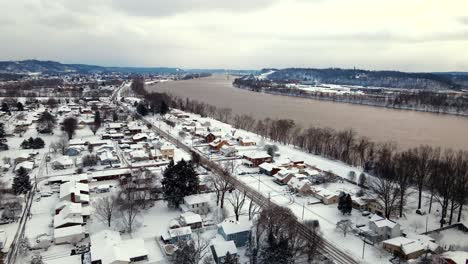 Aerial-view-of-Ohio-River-and-city-covered-in-snow-during-winter